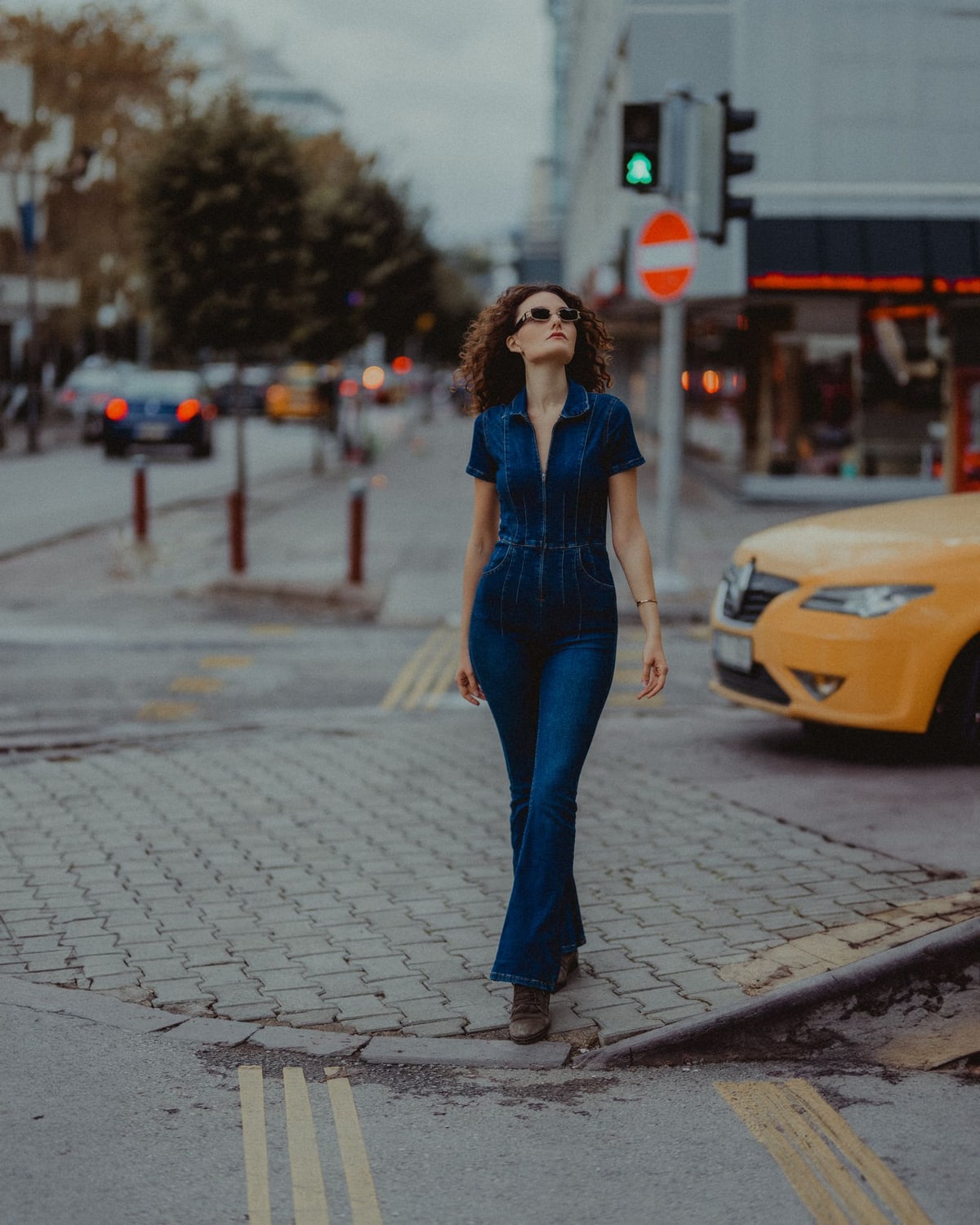 Woman in light denim standing in natural daylight